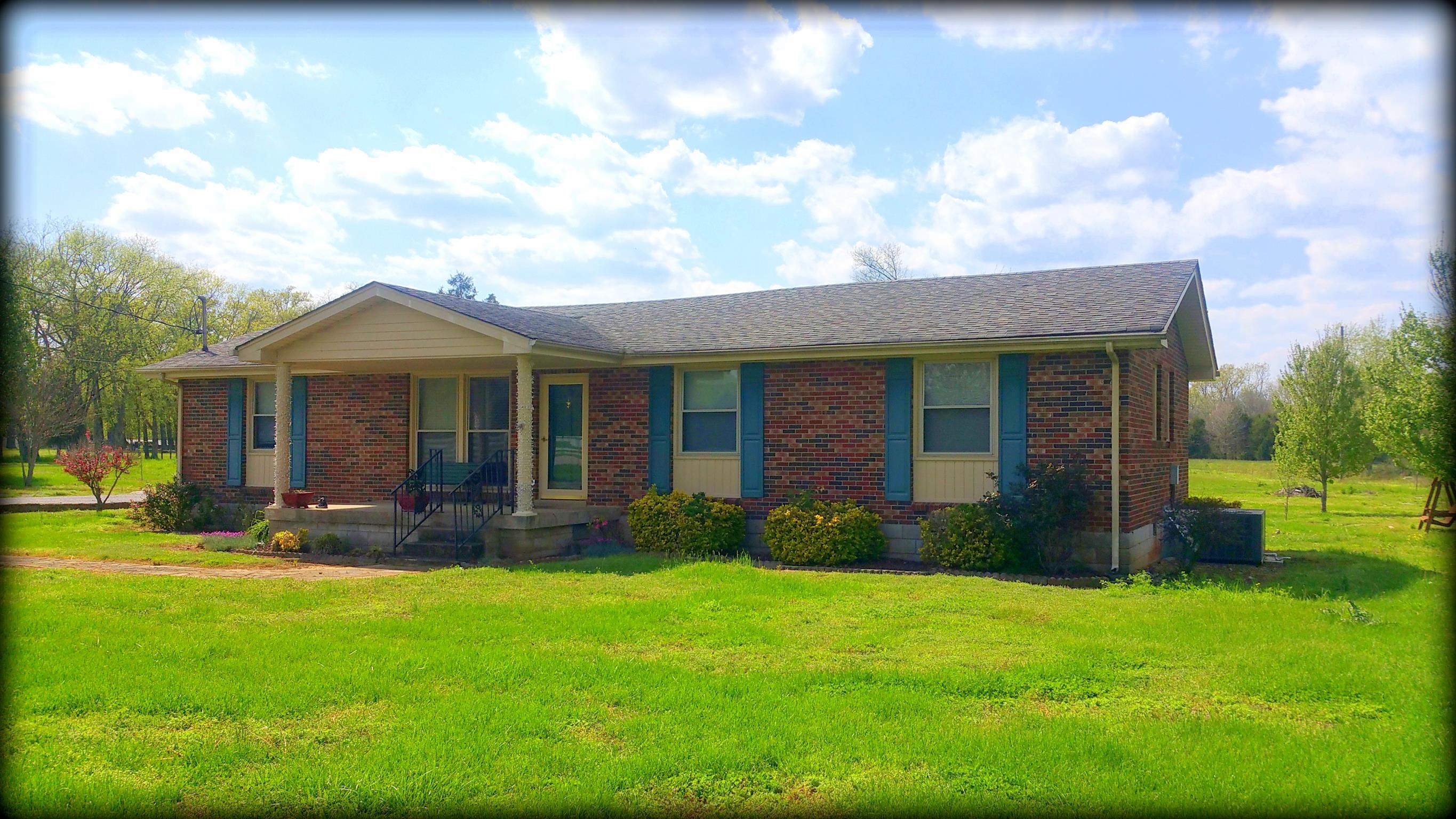 2656 Cairo Bend Road Lebanon, TN 37087 - Photo 1 of 18 a view of a brick house with a yard potted plants and a table