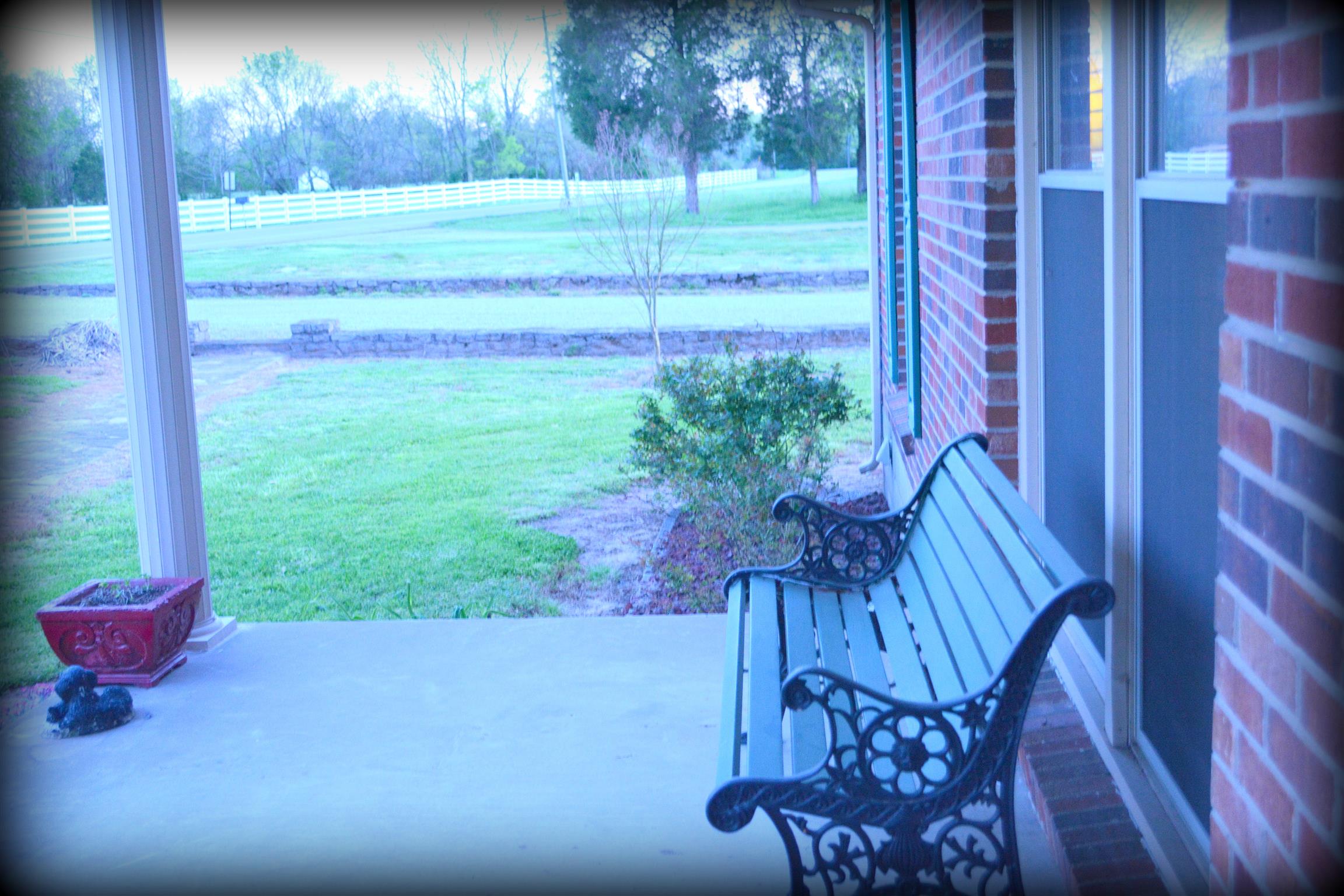 2656 Cairo Bend Road Lebanon, TN 37087 - Photo 7 of 18 a view of a porch with a couches chairs and potted plants