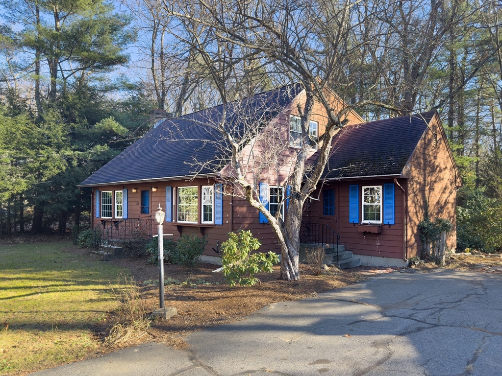 a view of a house with a yard next to a road
