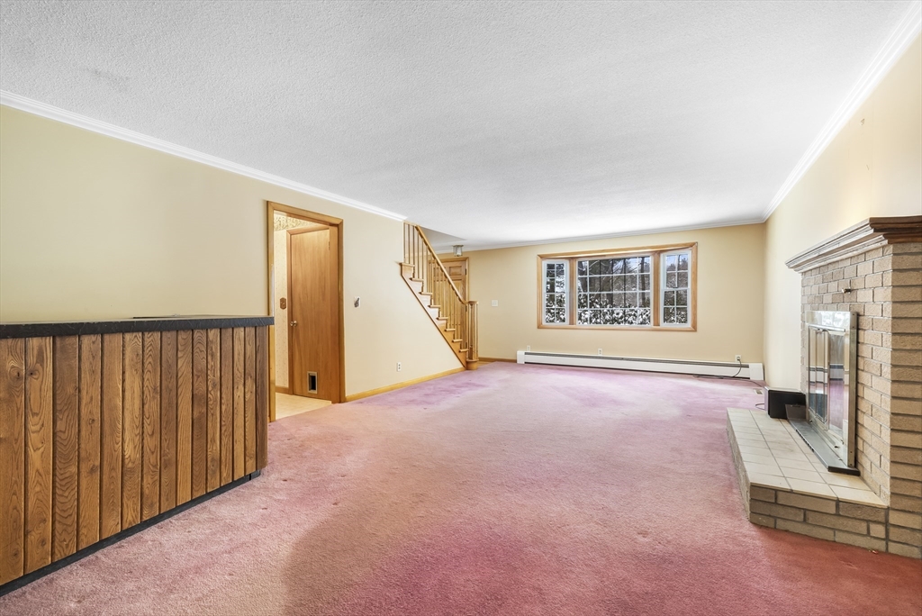 130 S Road Holden, MA 01520 - Photo 14 of 28 an empty room with a fireplace and windows