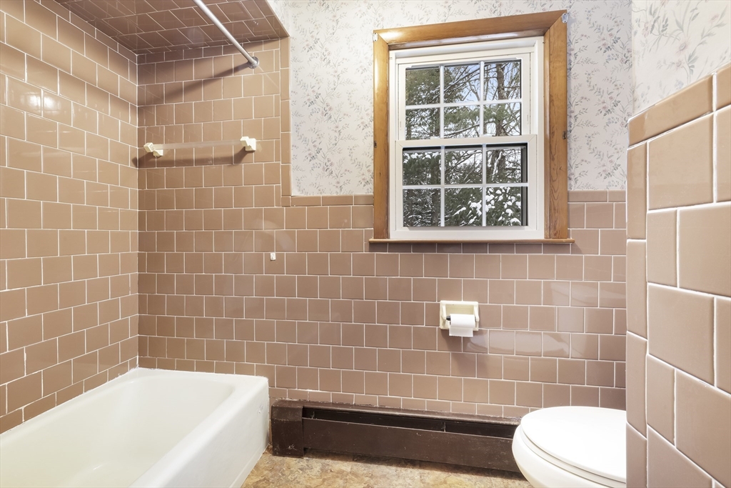 130 S Road Holden, MA 01520 - Photo 17 of 28 a bathroom with a bathtub and window