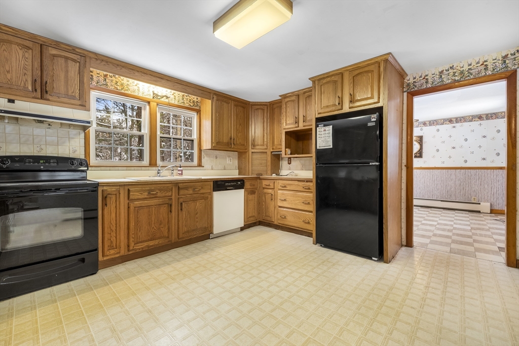 130 S Road Holden, MA 01520 - Photo 6 of 28 a kitchen with a refrigerator and a stove
