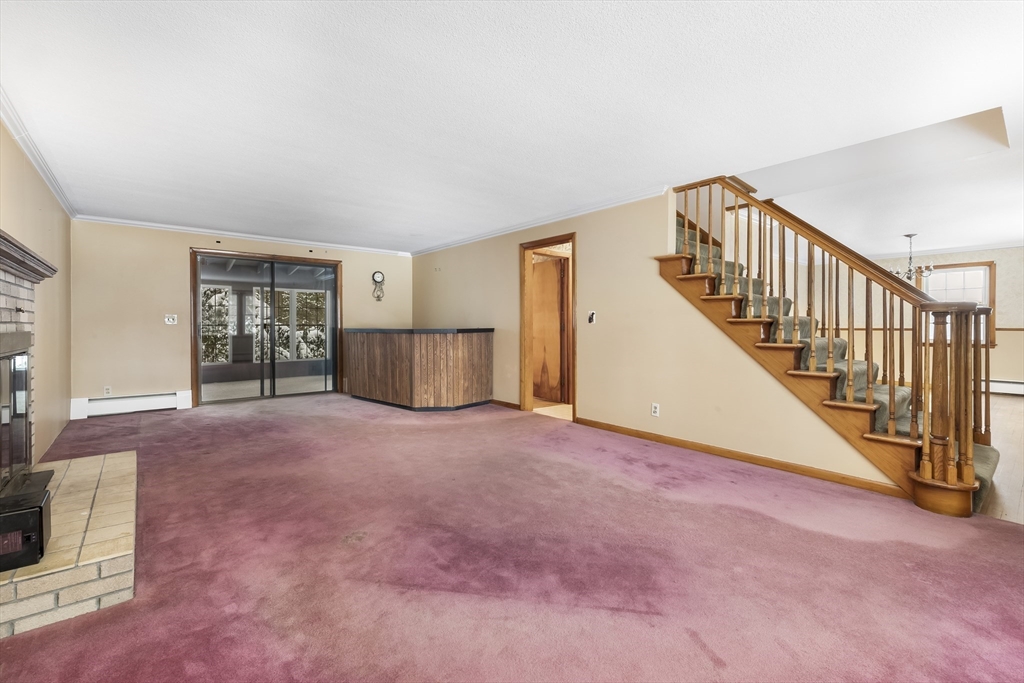 130 S Road Holden, MA 01520 - Photo 10 of 28 a view of an empty room with stairs and a window