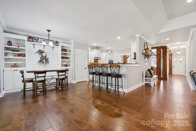 a dining room with furniture and wooden floor