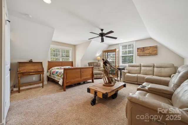a bedroom with furniture and a ceiling fan