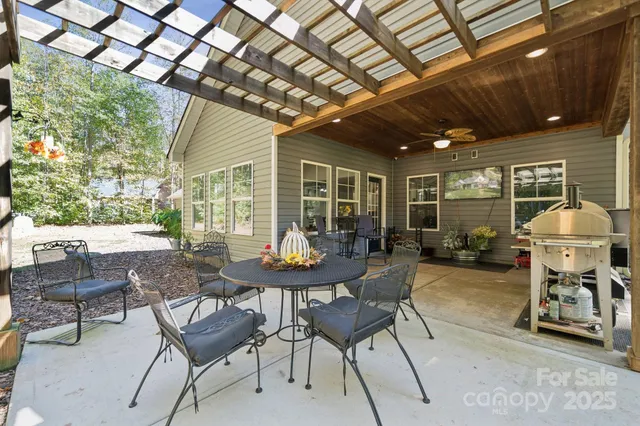 a view of a patio with table and chairs and potted plants