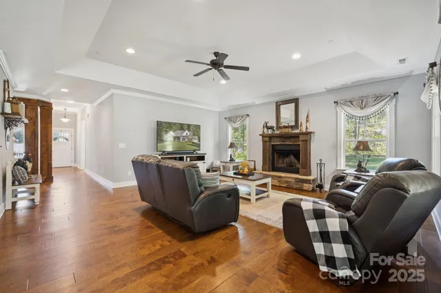 a living room with furniture a fireplace and a flat screen tv