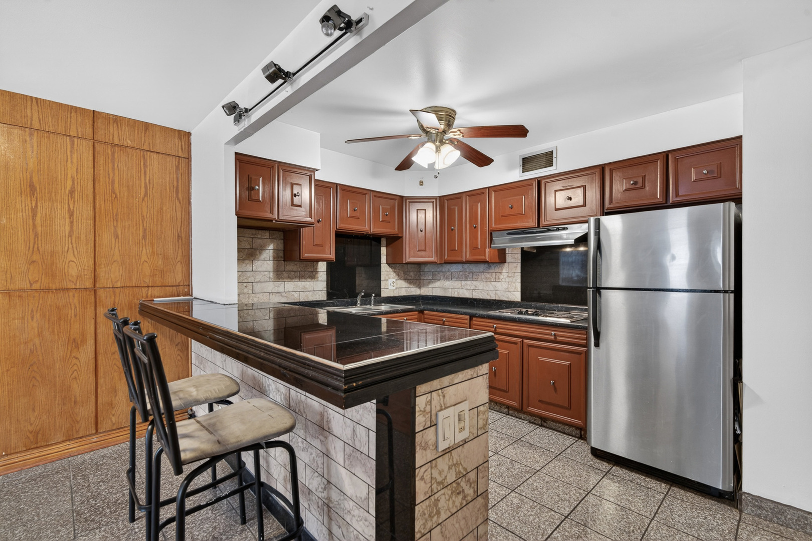 5901 North Sheridan Road, Unit 7G Chicago, IL 60660 - Photo 4 of 21 a kitchen with stainless steel appliances granite countertop a sink counter space and a refrigerator