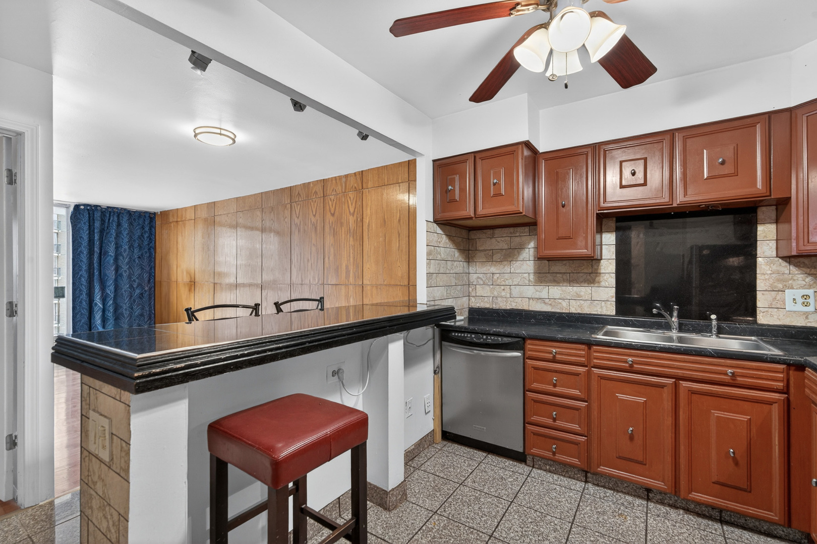 5901 North Sheridan Road, Unit 7G Chicago, IL 60660 - Photo 5 of 21 a kitchen with stainless steel appliances granite countertop a sink and a refrigerator