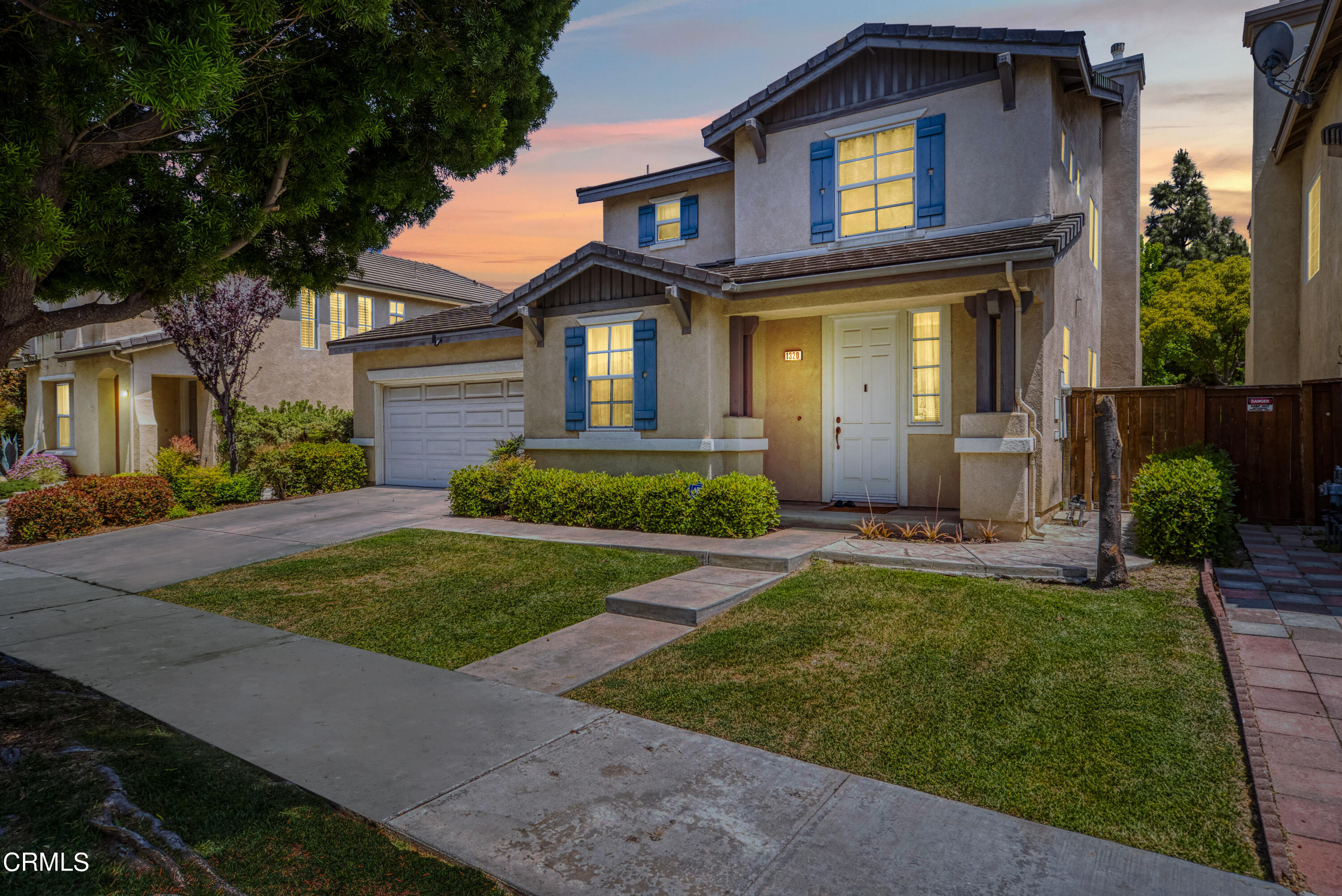 1320 Ribera Place Oxnard, CA 93030 - Photo 1 of 3 a front view of a house with a yard