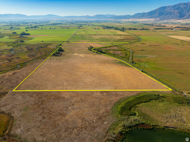 100 South 3600 West Logan, UT 84321 - Photo 2 of 10 View of rural area featuring a mountain backdrop and property boundaries highlighted