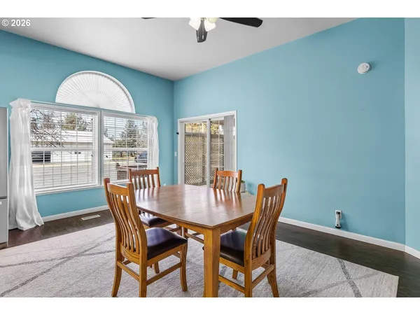 a view of a dining room with furniture and wooden floor