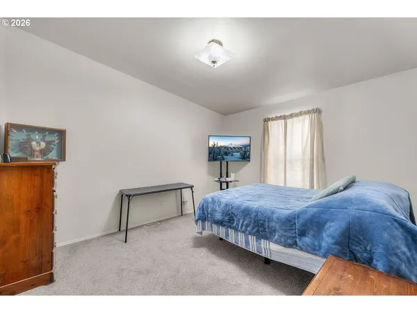 a bedroom with a bed and window