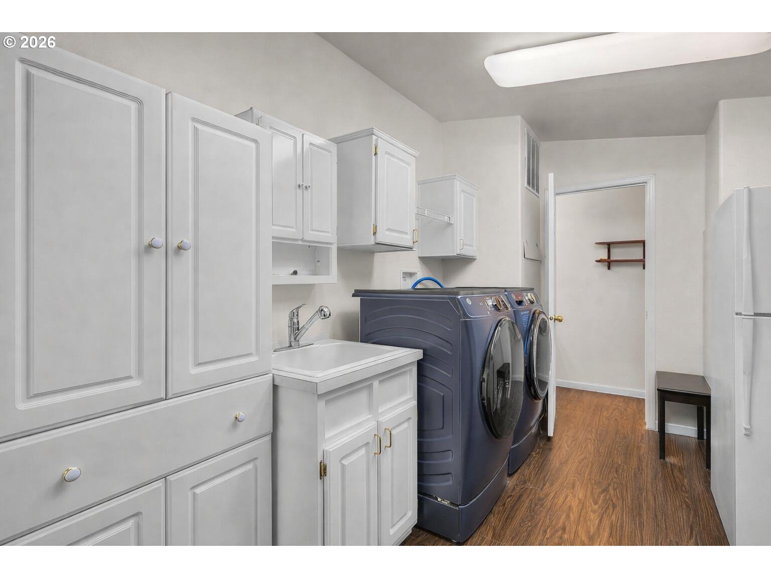 6983 Mustang Road Terrebonne, OR 97760 - Photo 22 of 36 a utility room with cabinets dryer and washer
