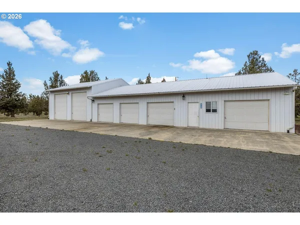 a view of a house with a backyard and a garage