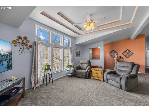 a living room with furniture chandelier and a large window