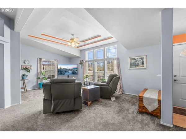 a living room with furniture and a large window