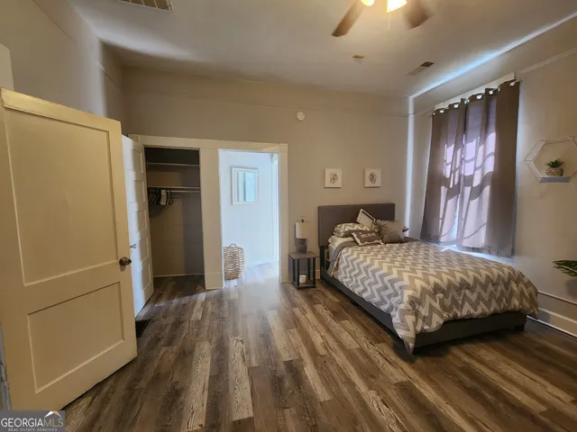 a bedroom with a bed and a walk in closet
