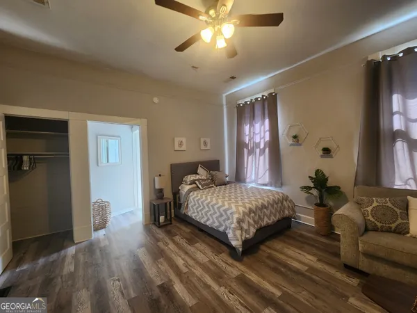 a bedroom with a bed and ceiling fan