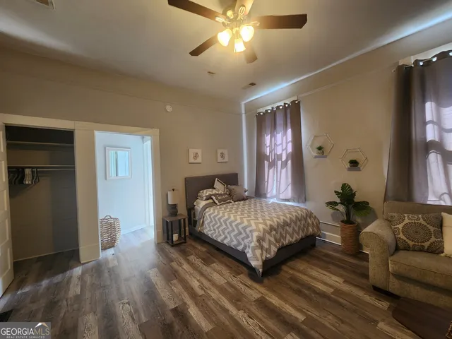 a bedroom with a bed and ceiling fan