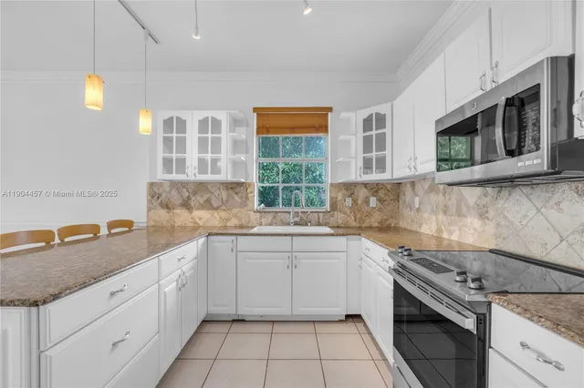 a kitchen that has a sink and a stove