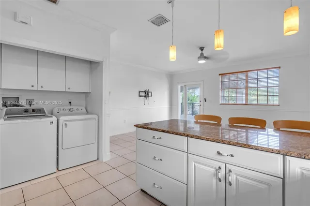 a kitchen with cabinets and window