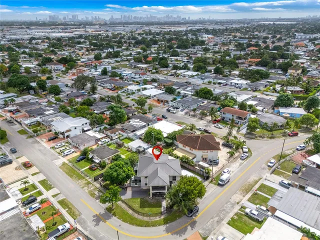 an aerial view of residential houses with outdoor space