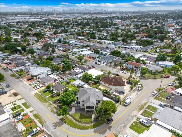 an aerial view of residential houses with outdoor space