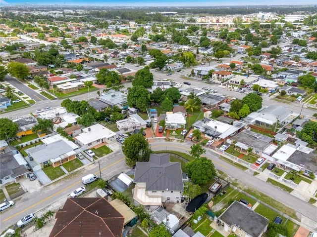 an aerial view of residential houses with outdoor space