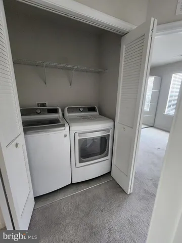 a view of a kitchen with washer and dryer