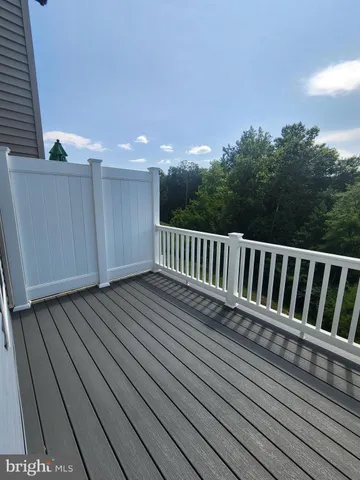 a view of deck with wooden floor and fence