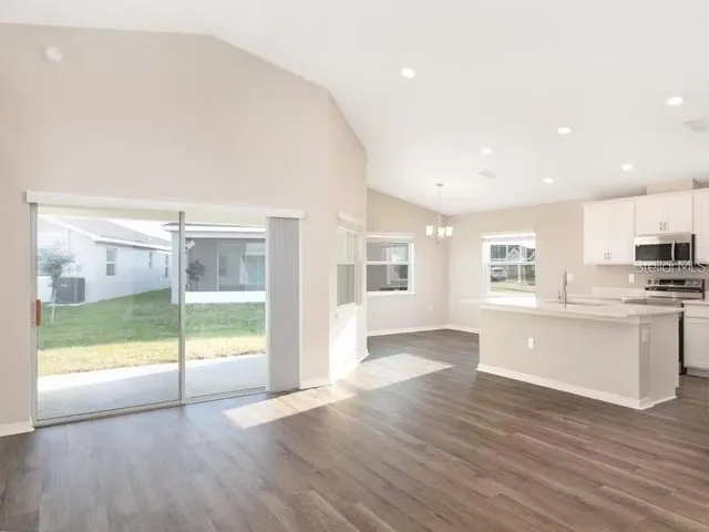 a view of a kitchen with a sink and a large window