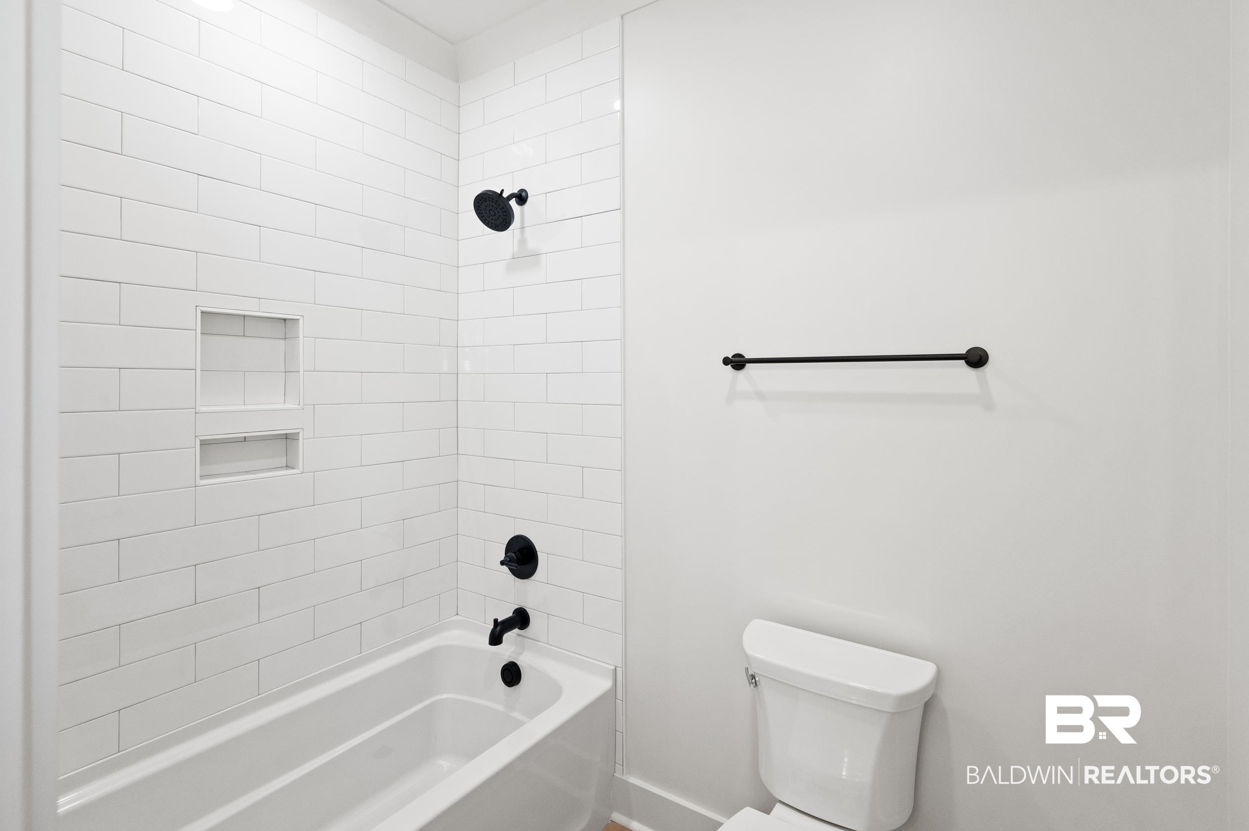 28889 Canal Road Orange Beach, AL 36561 - Photo 22 of 55 Bathroom with tiled shower / bath combo and toilet