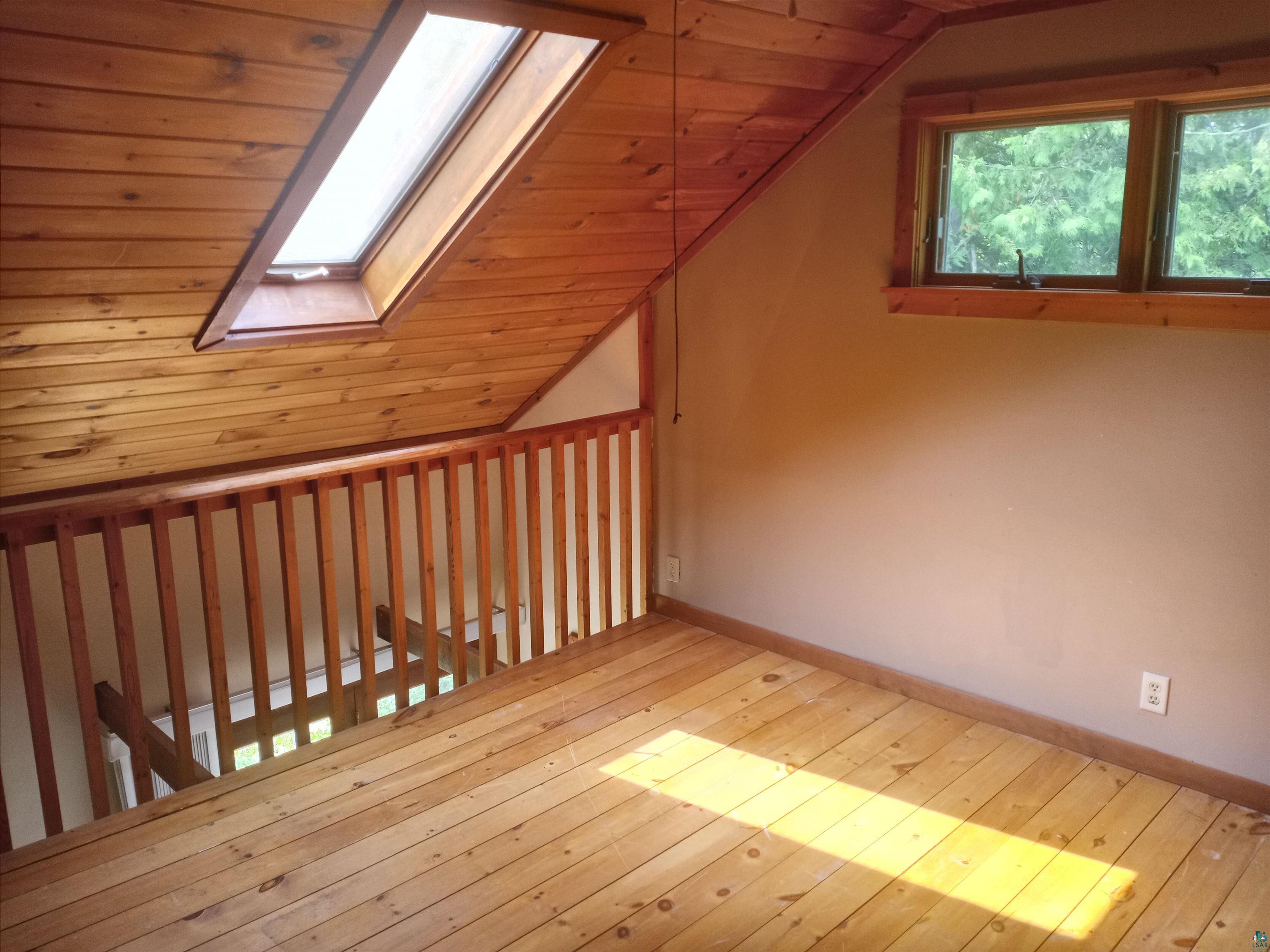 22715 Elm Street Cornucopia, WI 54827 - Photo 21 of 23 Loft Bedroom with skylight