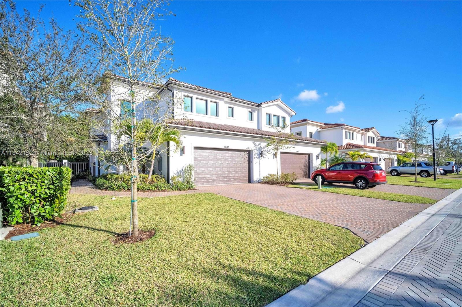 a view of a house with a yard and table and chairs