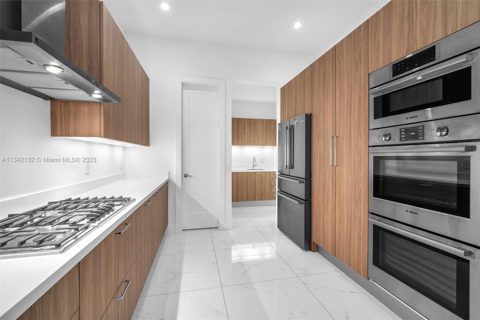 5840 Brookfield Circle Hollywood, FL 33312 - Photo 18 of 45 a kitchen with stainless steel appliances kitchen island granite countertop a refrigerator and a stove top oven