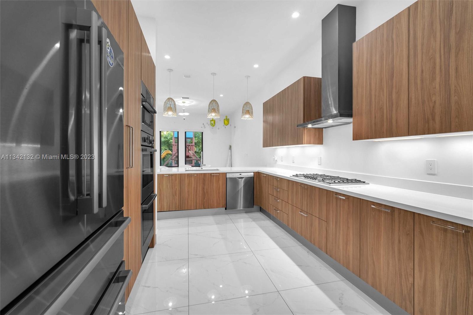 5840 Brookfield Circle Hollywood, FL 33312 - Photo 19 of 45 a large kitchen with stainless steel appliances a refrigerator and a sink