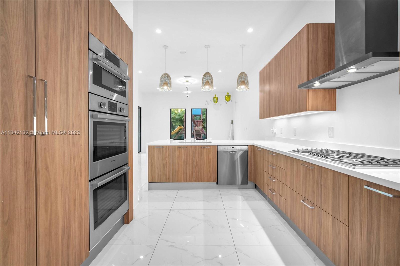 5840 Brookfield Circle Hollywood, FL 33312 - Photo 20 of 45 a kitchen with stainless steel appliances granite countertop a stove a sink and a refrigerator