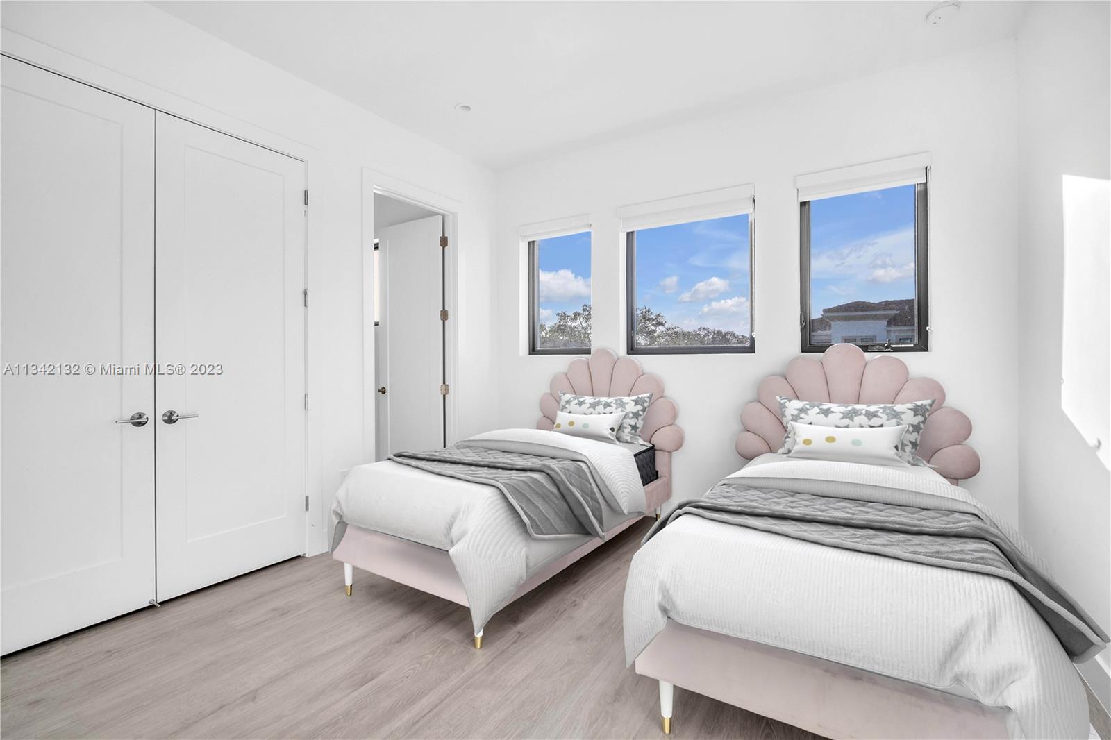 5840 Brookfield Circle Hollywood, FL 33312 - Photo 27 of 45 a spacious bedroom with two beds and a painting on the wall