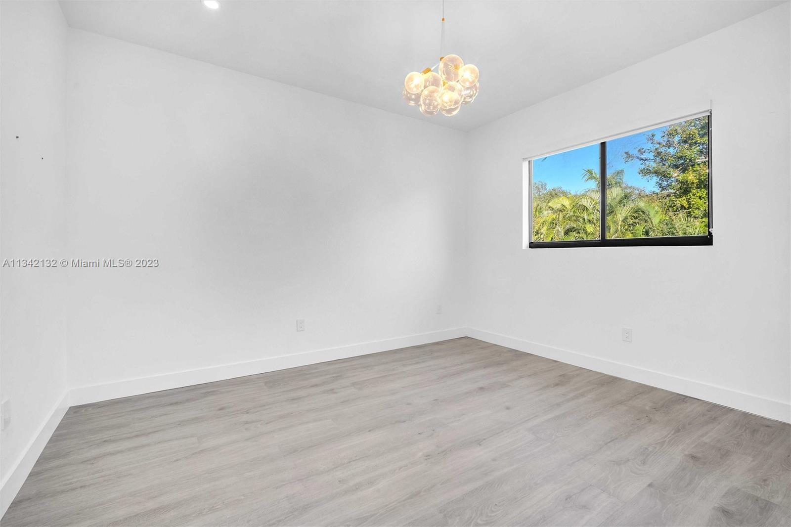 5840 Brookfield Circle Hollywood, FL 33312 - Photo 30 of 45 a view of empty room with wooden floor and window