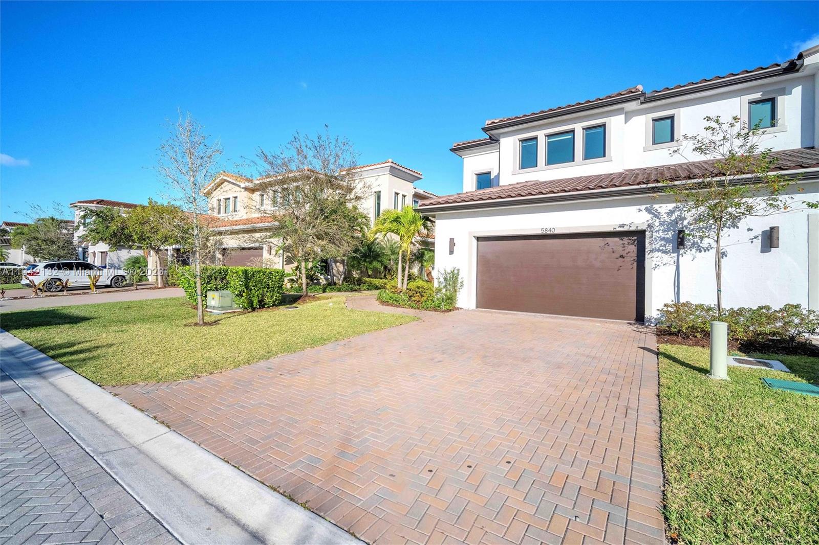 5840 Brookfield Circle Hollywood, FL 33312 - Photo 3 of 45 a front view of a house with a yard and garage