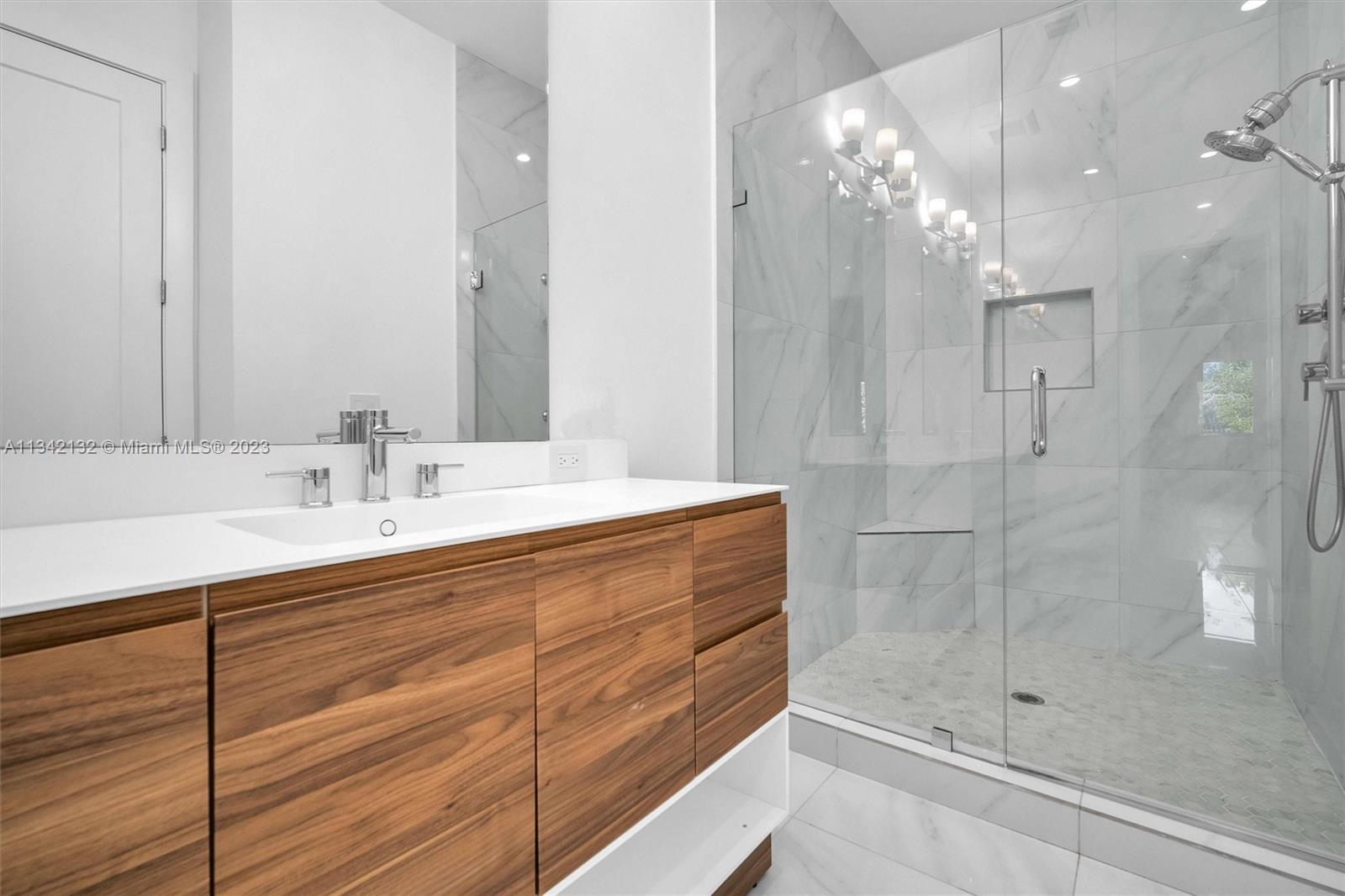 5840 Brookfield Circle Hollywood, FL 33312 - Photo 35 of 45 a bathroom with a sink shower and a mirror