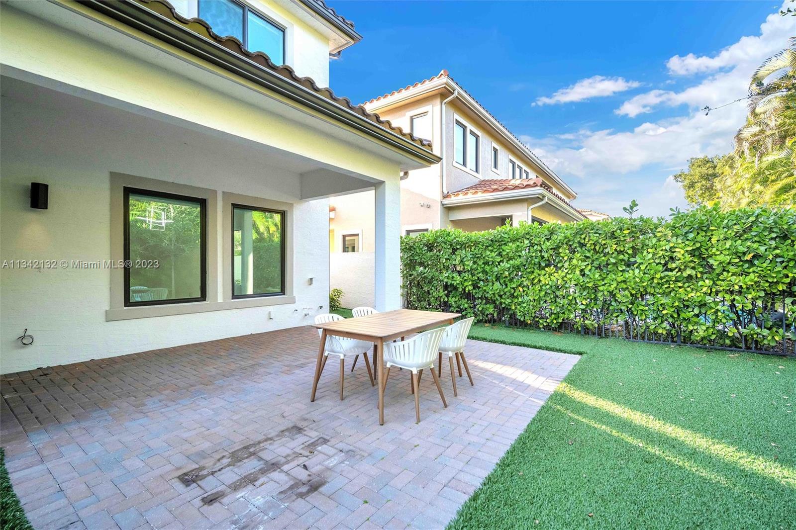 5840 Brookfield Circle Hollywood, FL 33312 - Photo 7 of 45 a view of a house with backyard sitting area and garden