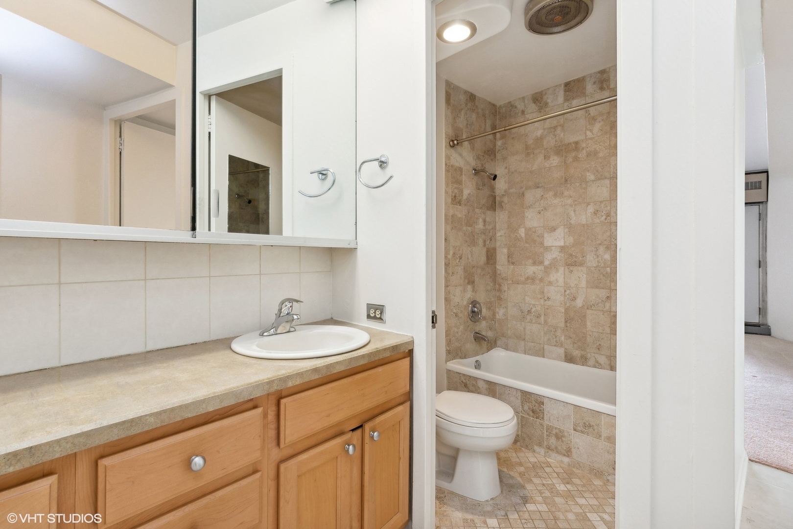 300 North State Street, Unit 4606 Chicago, IL 60654 - Photo 9 of 15 a bathroom with a granite countertop sink toilet a mirror and shower