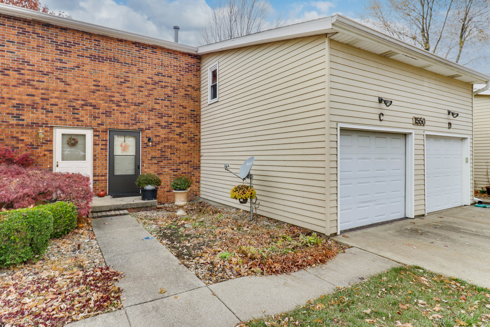 1550 Hunt Drive, Unit C Normal, IL 61761 - Photo 1 of 21 a front view of a house with patio