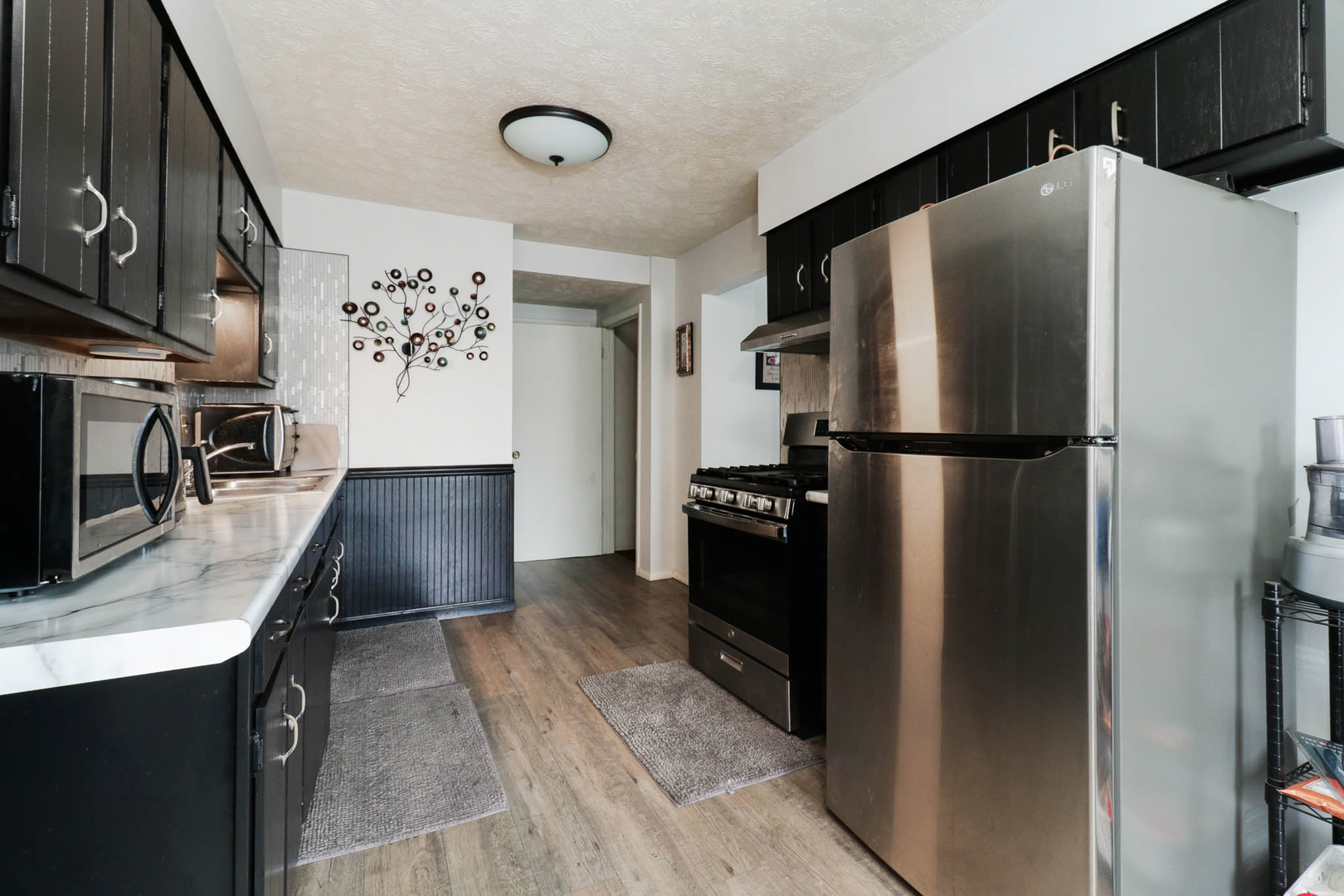 1550 Hunt Drive, Unit C Normal, IL 61761 - Photo 6 of 21 a kitchen with stainless steel appliances a refrigerator and a stove top oven