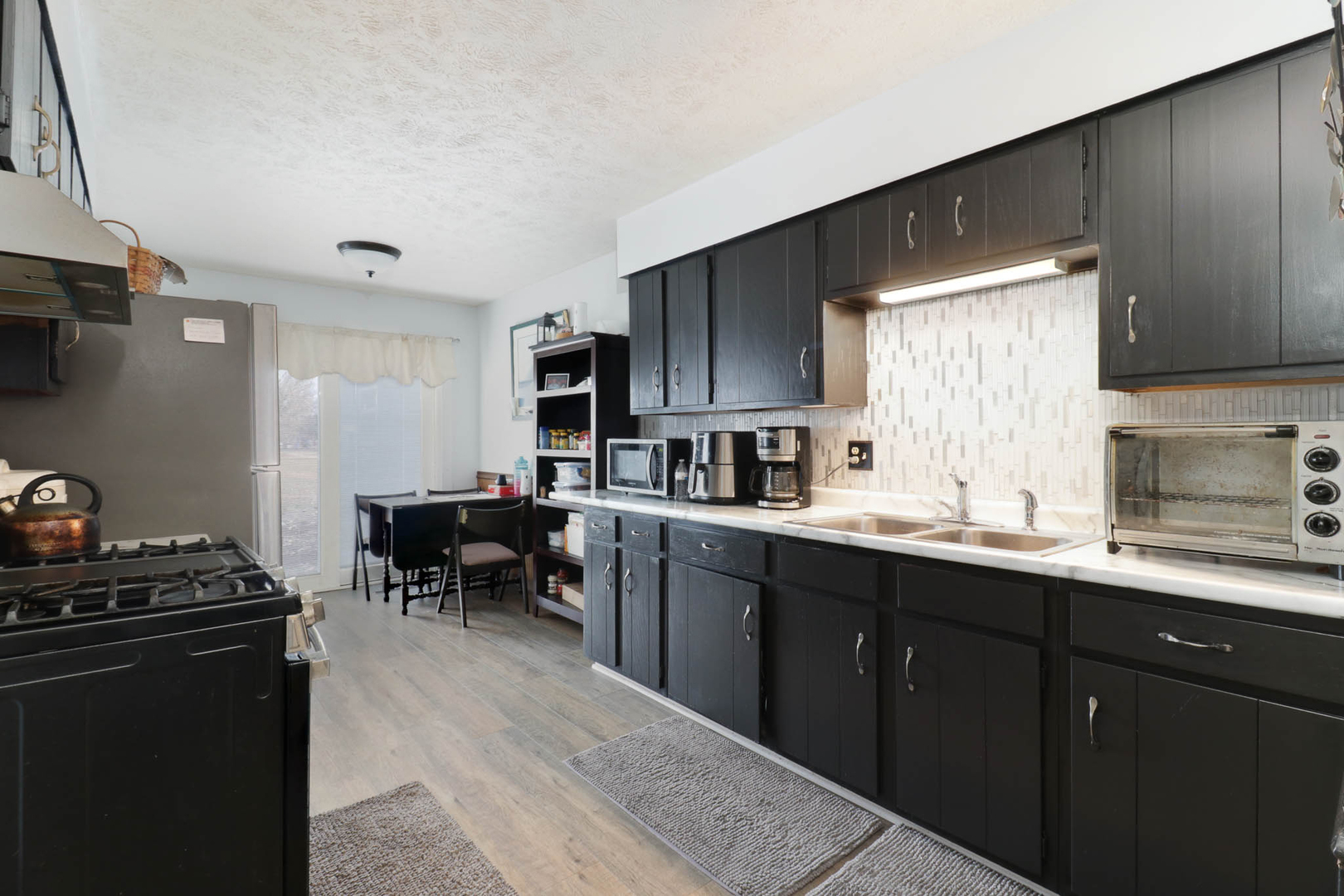 1550 Hunt Drive, Unit C Normal, IL 61761 - Photo 7 of 21 a kitchen with a sink stove and cabinets