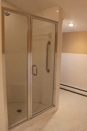 a bathroom with a glass shower door