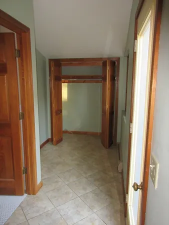 an empty room with closet and a bathroom