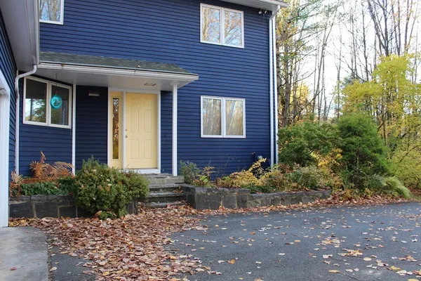 a view of brick house with a yard